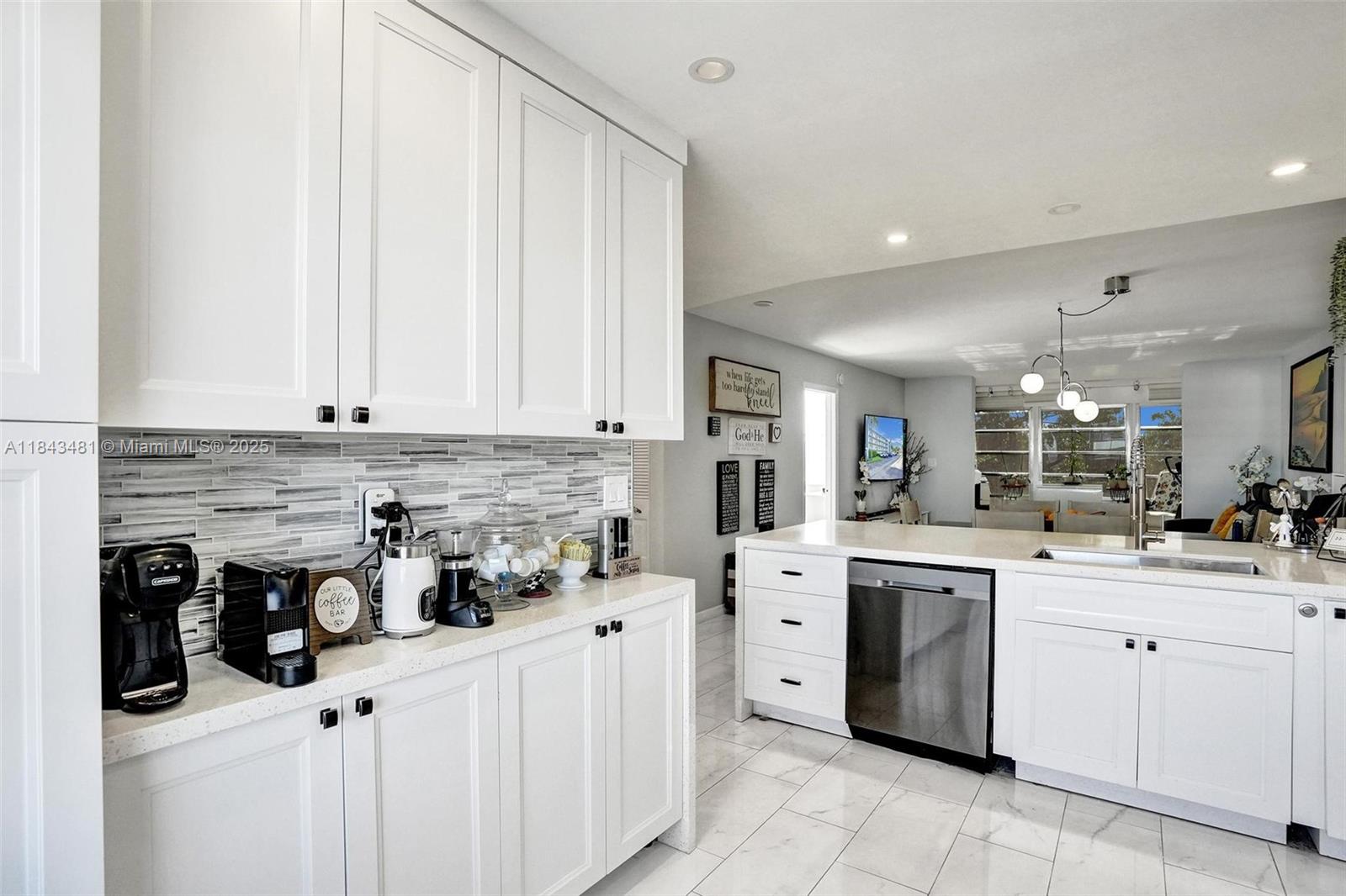 7664 Northwest 18th Street, Unit 405 Margate, FL 33063 - Photo 9 of 46 a kitchen with white cabinets and appliances