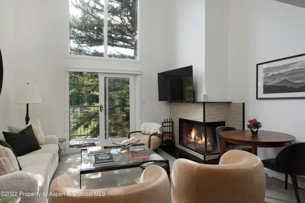 a living room with furniture fireplace and window