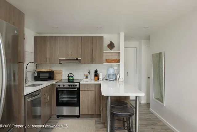 a kitchen with a stove a sink and a refrigerator