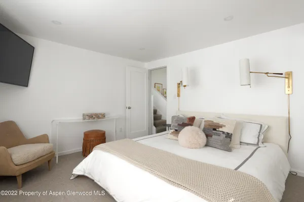 a bedroom with a bed and a couch