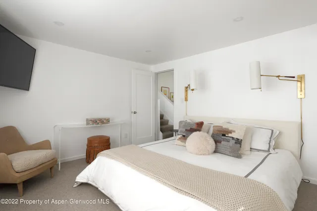 a bedroom with a bed and a couch