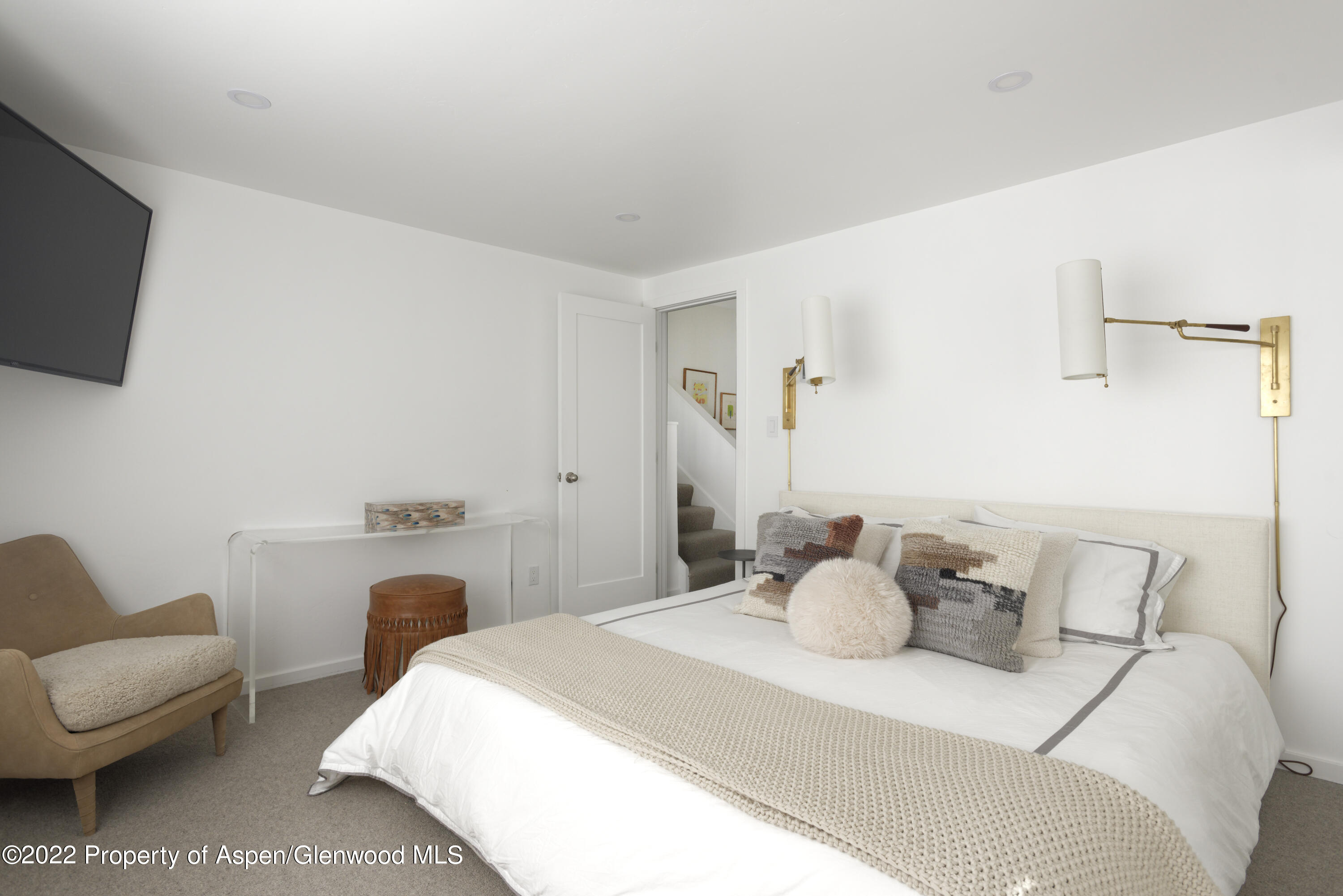 1050 Waters Avenue, Unit 14 Aspen, CO 81611 - Photo 6 of 19 a bedroom with a bed and a couch