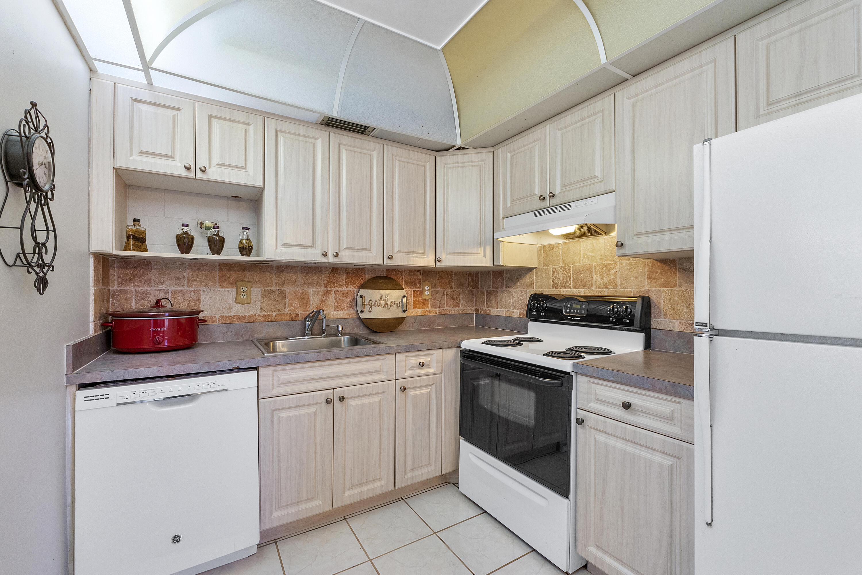 157 Flanders C Delray Beach, FL 33484 - Photo 12 of 45 a kitchen with cabinets stainless steel appliances and a sink