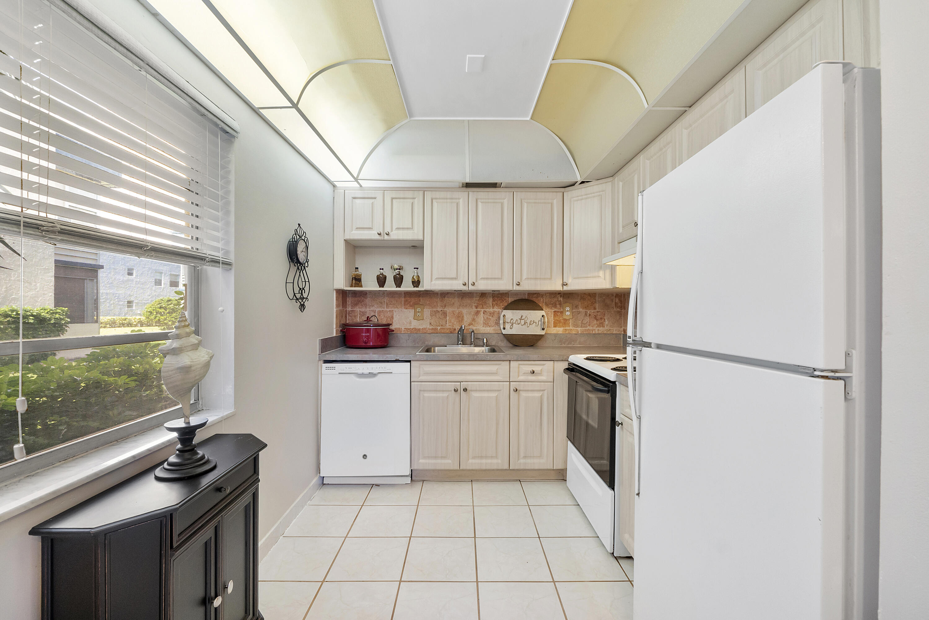 157 Flanders C Delray Beach, FL 33484 - Photo 13 of 45 a kitchen with a stove a refrigerator and a sink