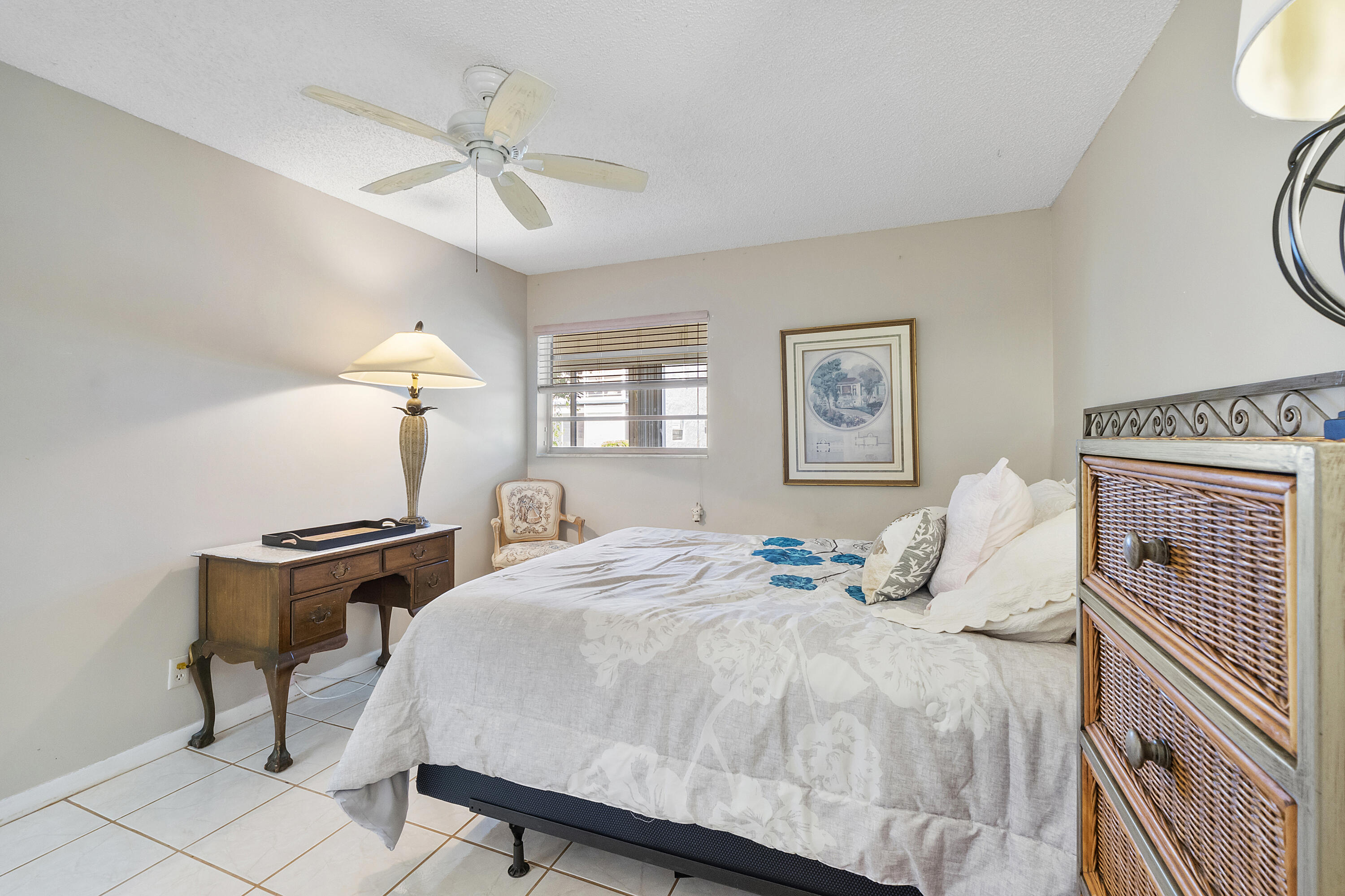 157 Flanders C Delray Beach, FL 33484 - Photo 15 of 45 a bedroom with a bed and a chandelier