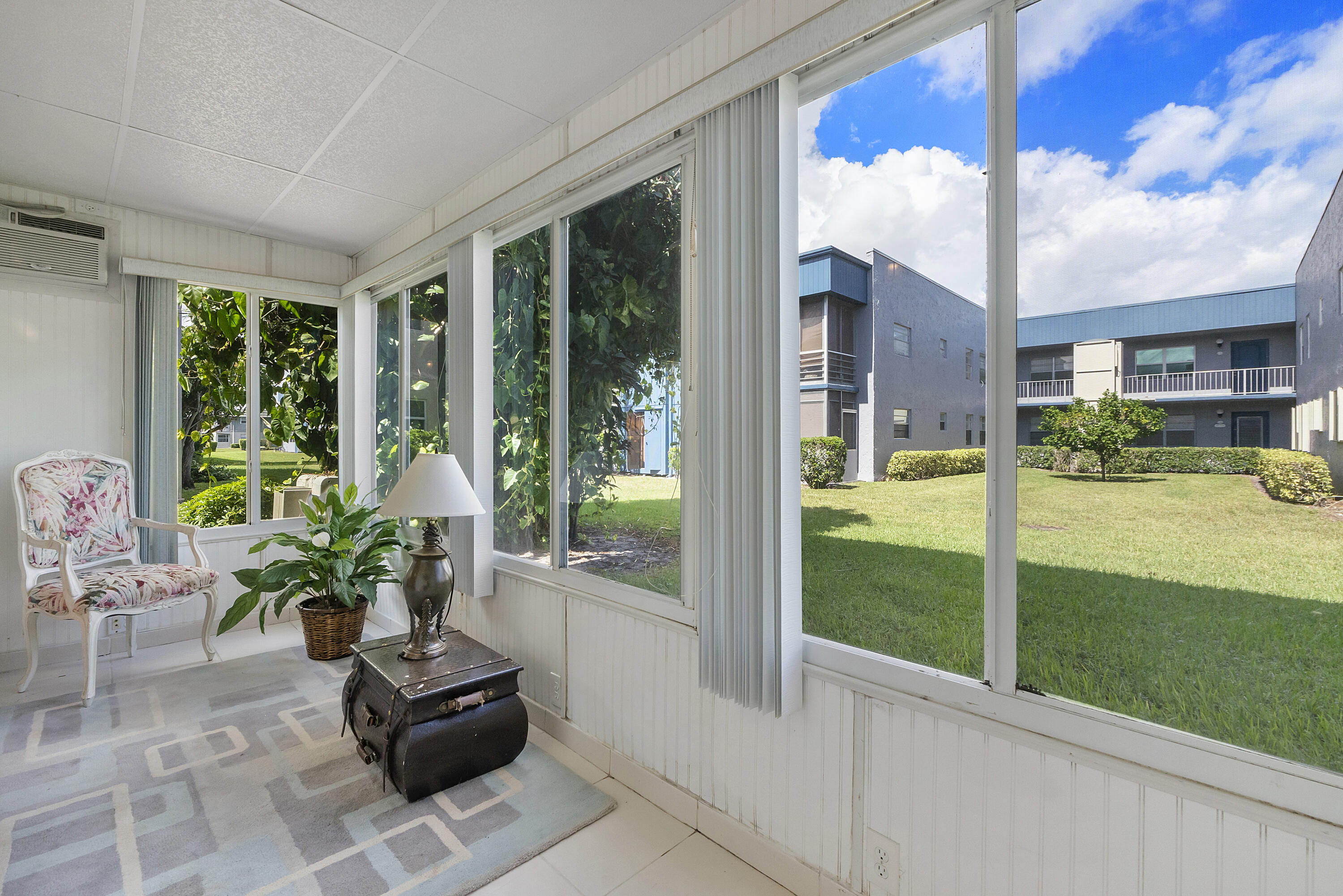 157 Flanders C Delray Beach, FL 33484 - Photo 24 of 45 a living room with furniture and garden view