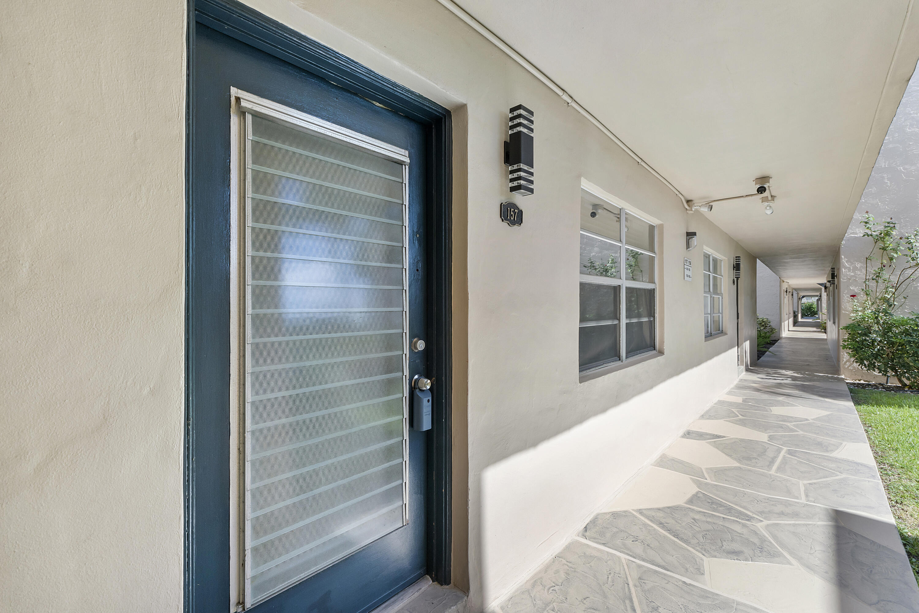 157 Flanders C Delray Beach, FL 33484 - Photo 28 of 45 a view of front door and bedroom