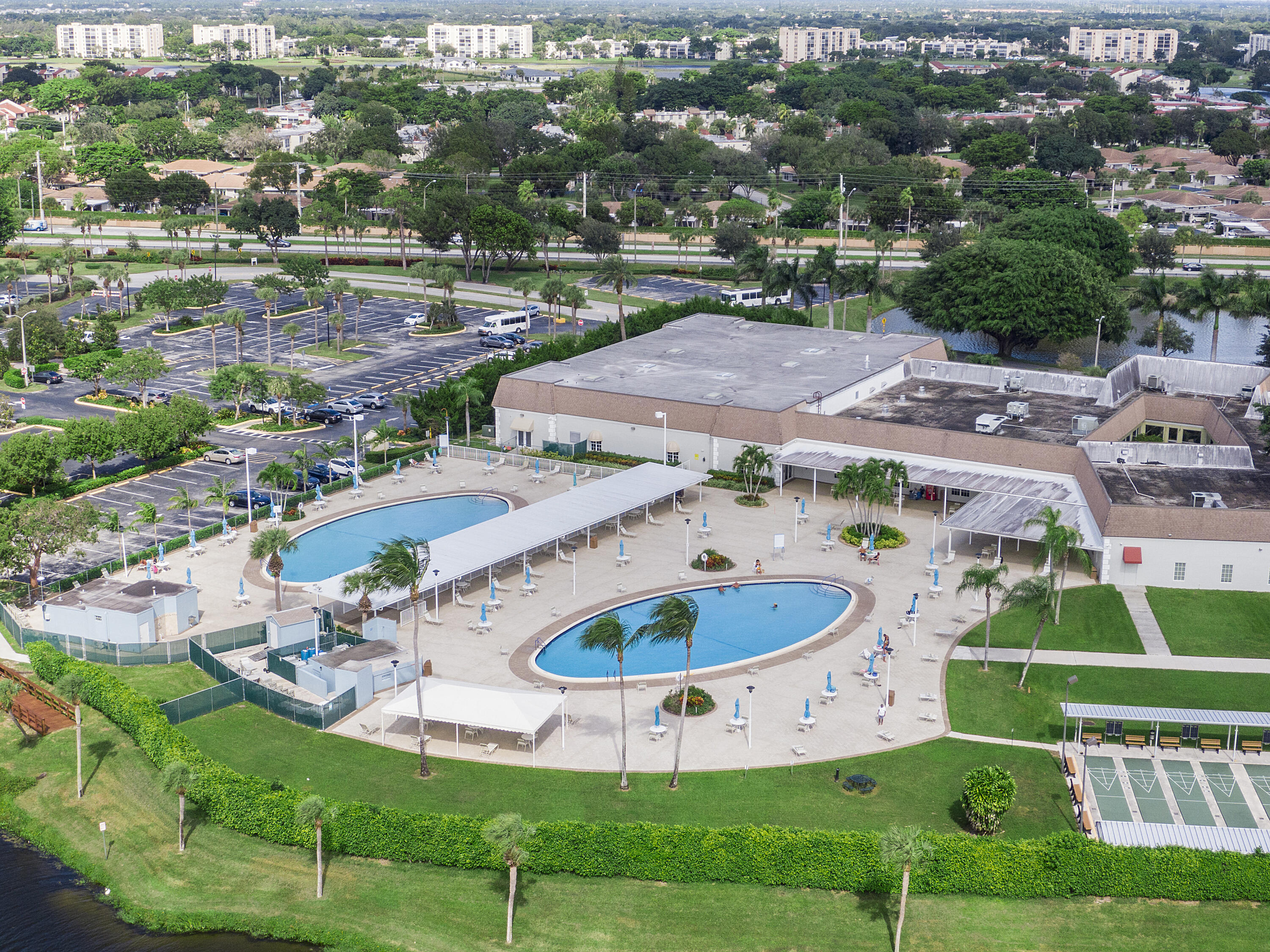 157 Flanders C Delray Beach, FL 33484 - Photo 38 of 45 a view of a swimming pool and outdoor space