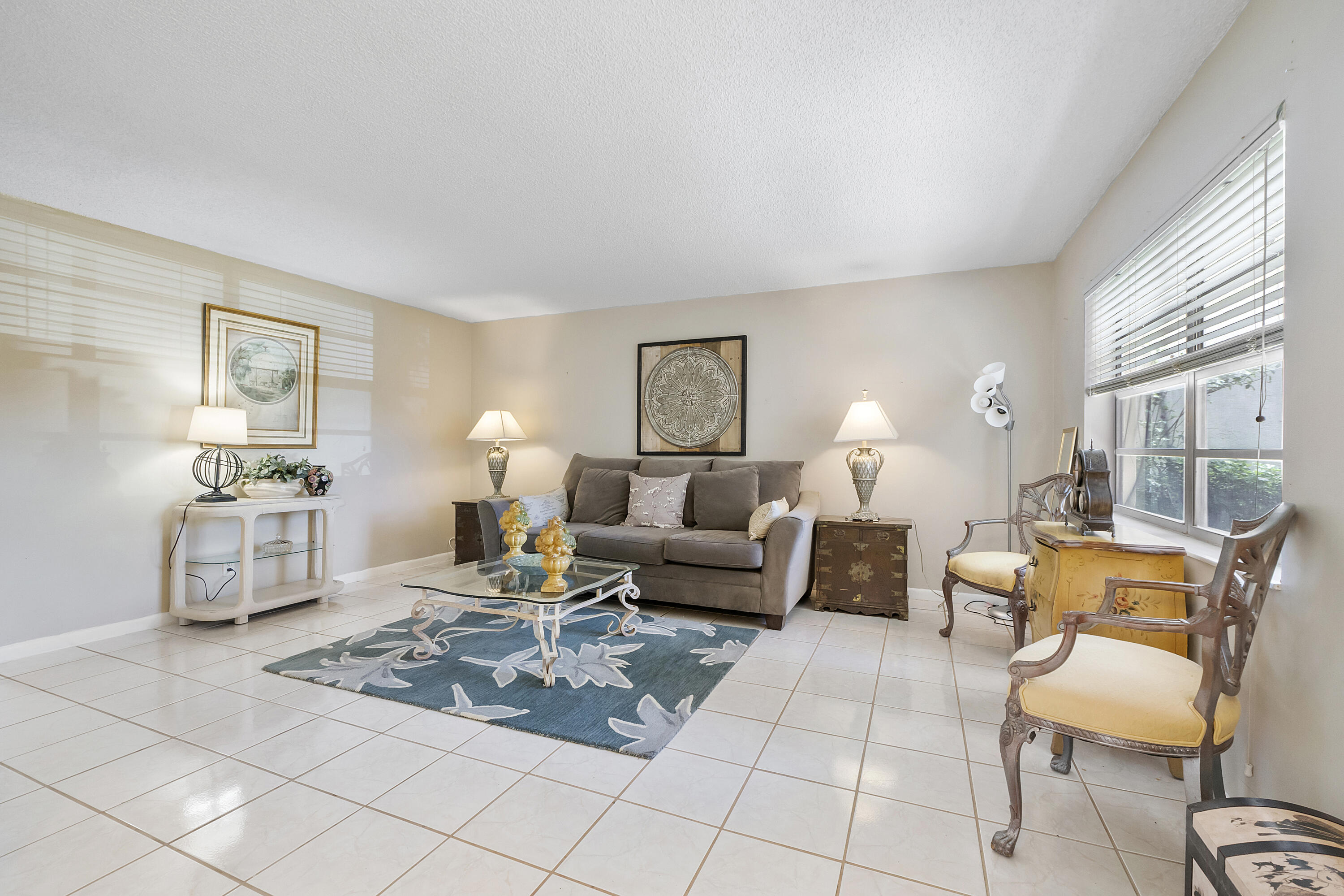 157 Flanders C Delray Beach, FL 33484 - Photo 4 of 45 a living room with furniture lamp and a large window