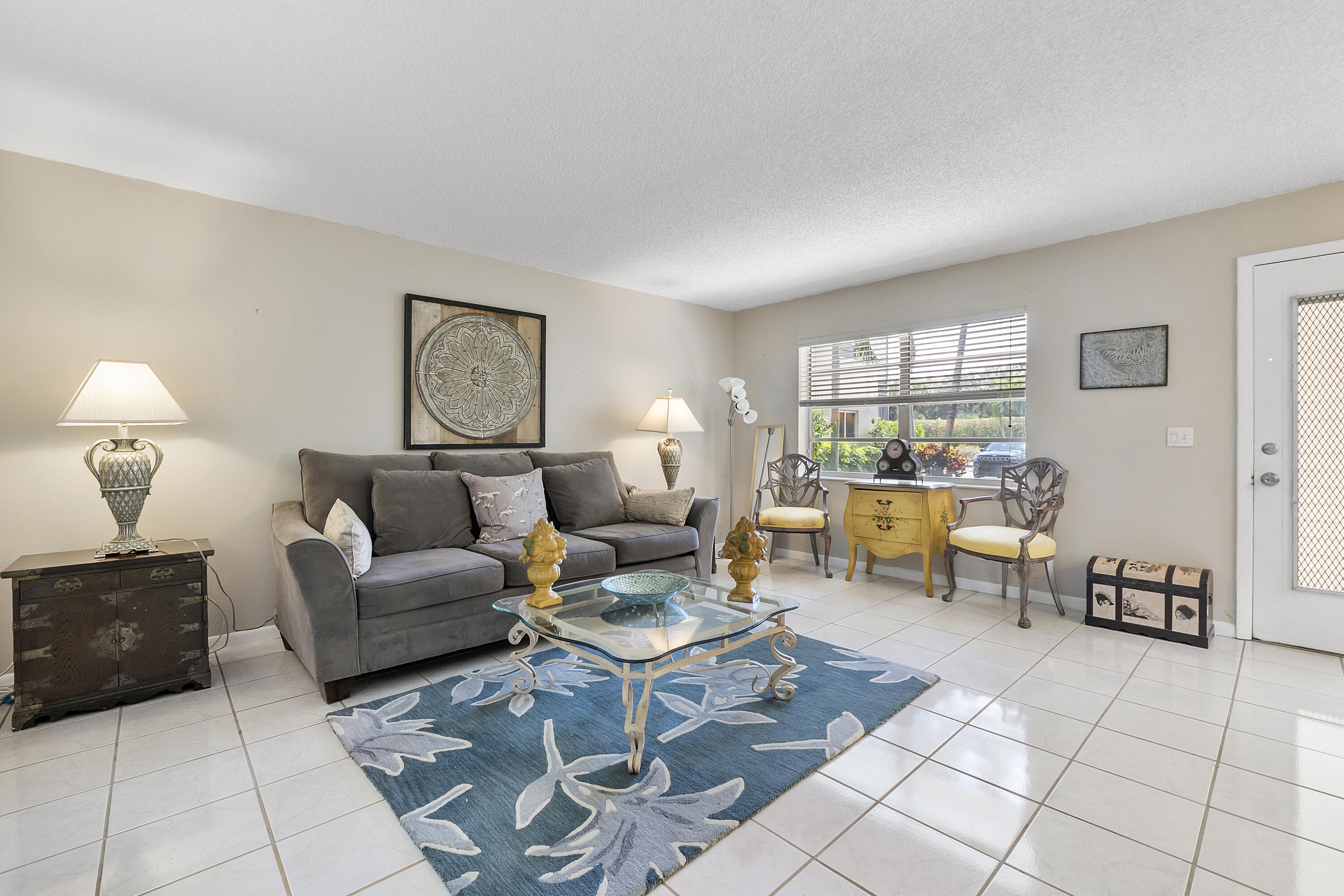 157 Flanders C Delray Beach, FL 33484 - Photo 6 of 45 a living room with furniture and a table