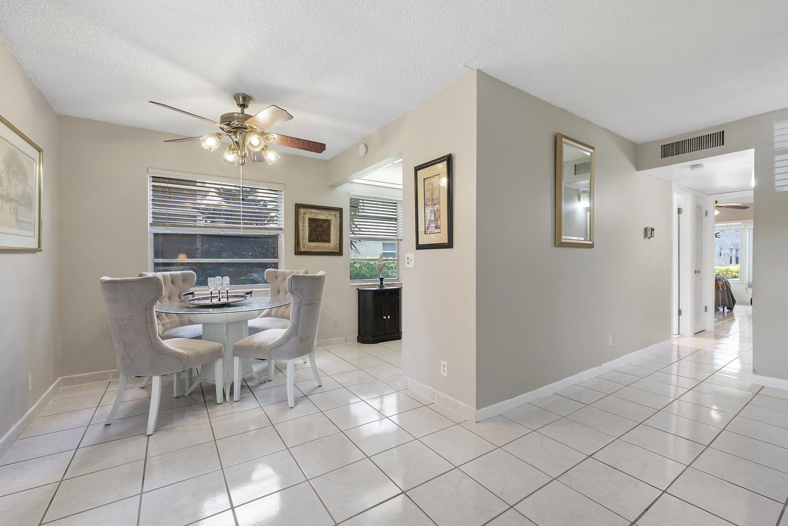 157 Flanders C Delray Beach, FL 33484 - Photo 7 of 45 a view of a livingroom with furniture and chandelier fan