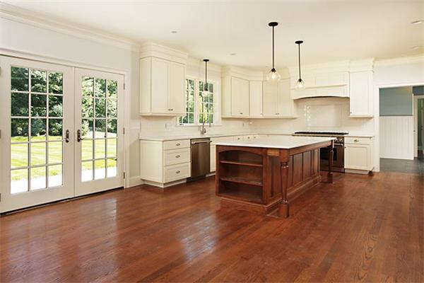 100 Wayne Road Newton, MA 02459 - Photo 5 of 14 a kitchen with stainless steel appliances granite countertop a stove a sink and white cabinets with wooden floor
