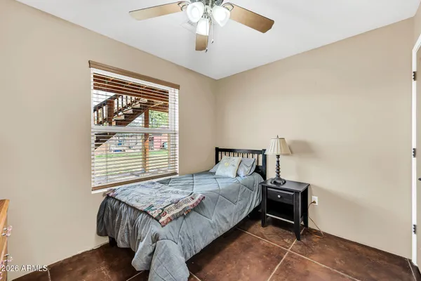 a spacious bathroom with a shower a sink and a large mirror