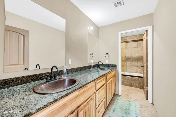 a room with chandelier fan and windows