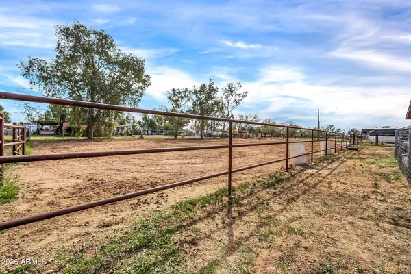 a view of a yard with wooden fence