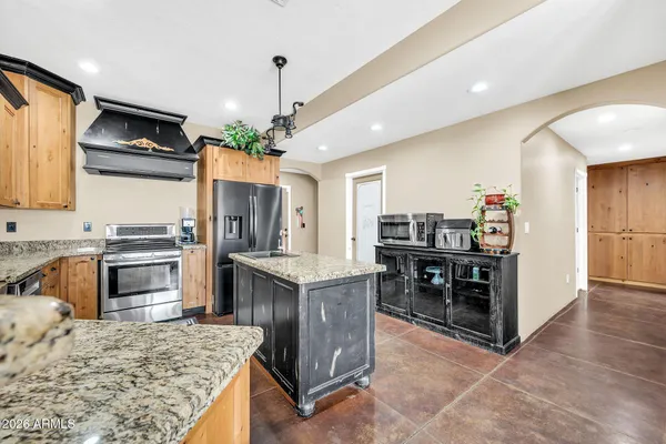 a kitchen with stainless steel appliances granite countertop a stove and cabinets