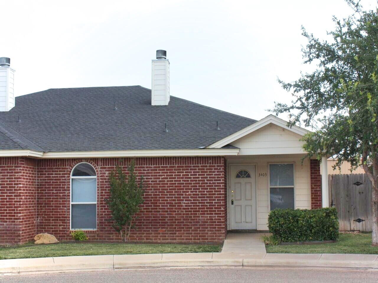 3403 97th Street Lubbock, TX 79423 - Photo 1 of 10 a front view of a house with a garden