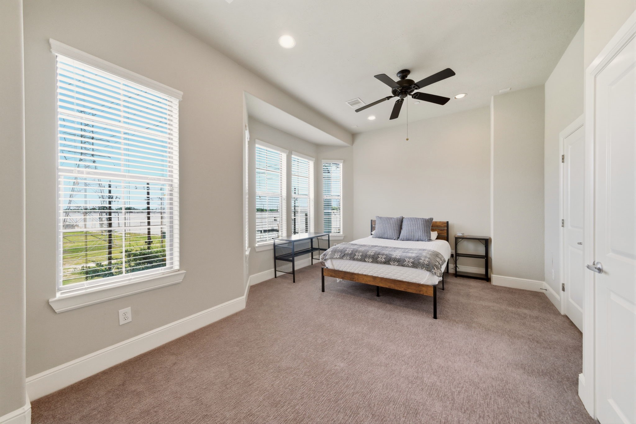 2110 Shearn Street, Unit 16 Houston, TX 77007 - Photo 15 of 37 Another look at the generous sized primary bedroom. Currently there is a Queen bed here, but a King will easily fit into the space! Door on the right is the en-suite bathroom