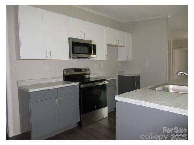123 Josiah Lane Hendersonville, NC 28792 - Photo 11 of 13 a kitchen with a sink and a stove top oven with wooden floor