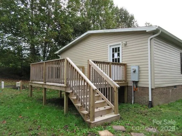a view of a house with a yard and deck
