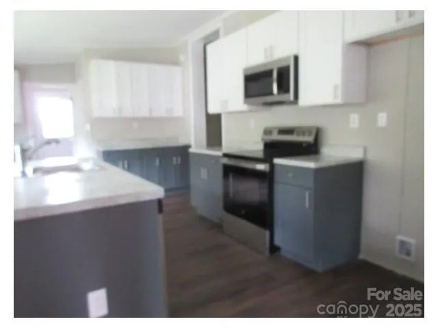 a kitchen with a sink and a microwave