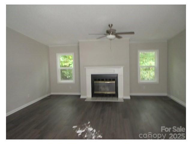 123 Josiah Lane Hendersonville, NC 28792 - Photo 9 of 13 an empty room with wooden floor fireplace and windows