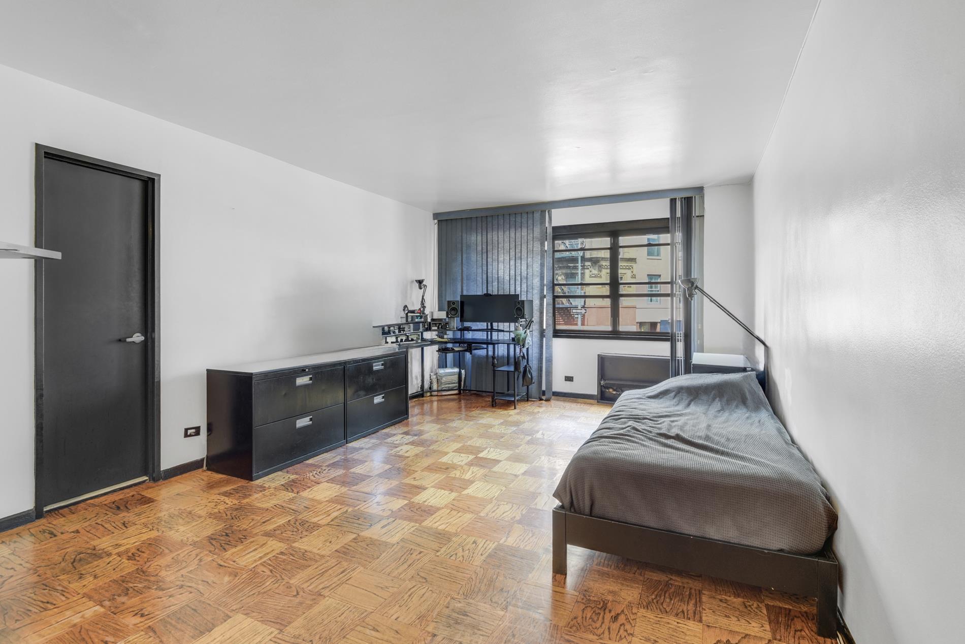 31 Jane Street, Unit 2H Manhattan, NY 10014 - Photo 3 of 10 a bed room with a bed and a window