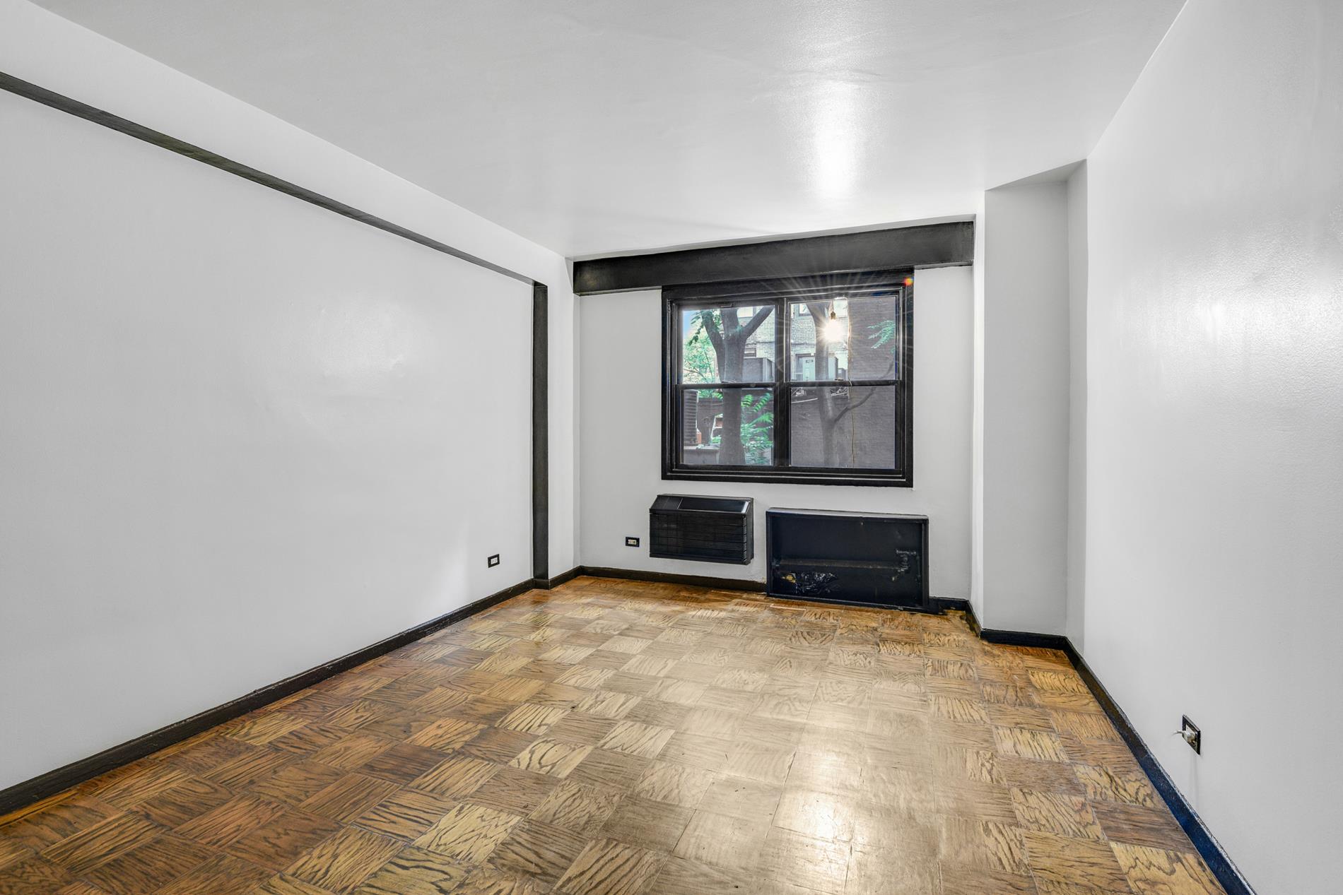 31 Jane Street, Unit 2H Manhattan, NY 10014 - Photo 5 of 10 an empty room with windows