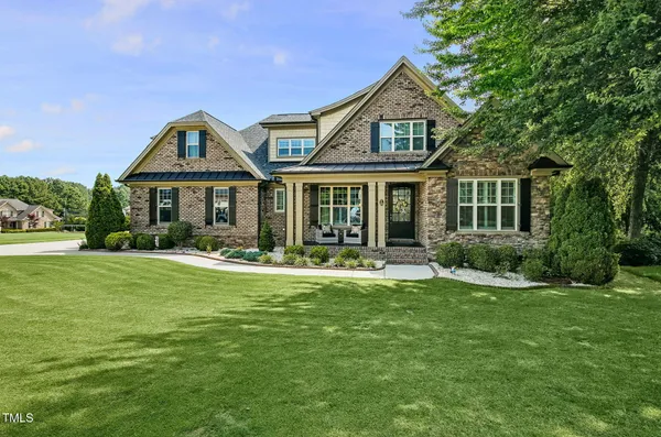 a front view of a house with a yard table and chairs