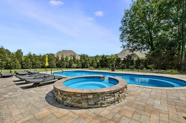 a view of swimming pool with seating space