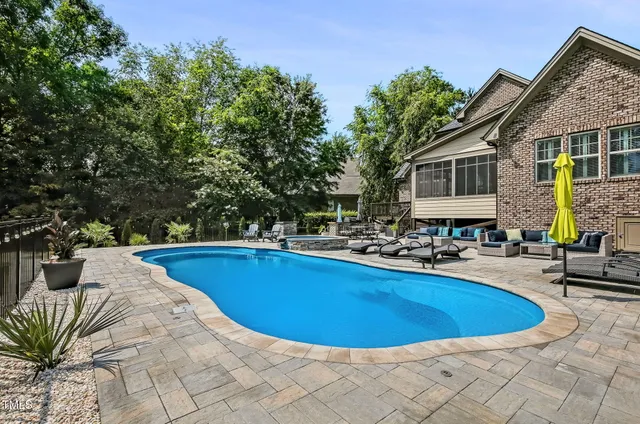 a view of a house with swimming pool and sitting area