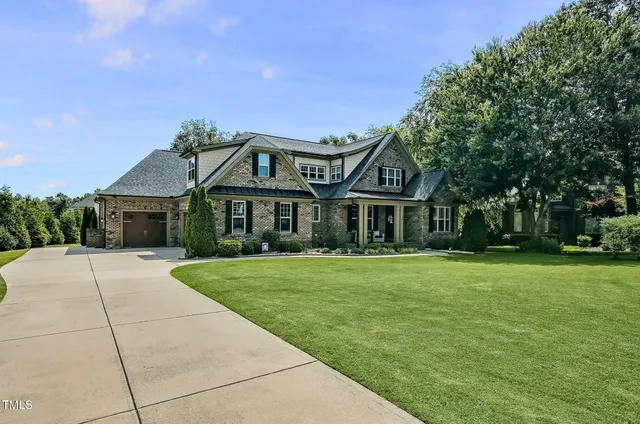 a front view of a house with a garden