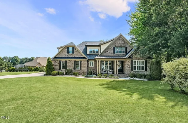 a front view of a house with a garden