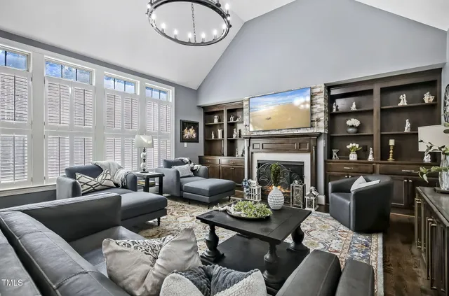 a living room with furniture a fireplace and a large window