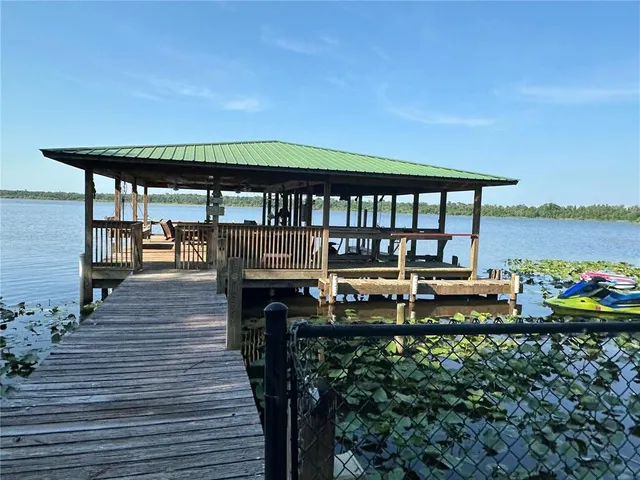 a roof deck with a table and chairs
