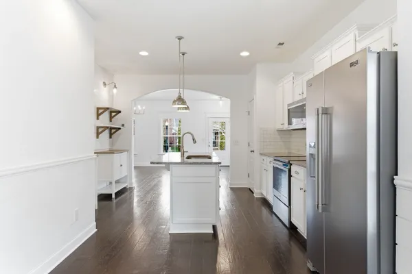 a large kitchen with cabinets and stainless steel appliances
