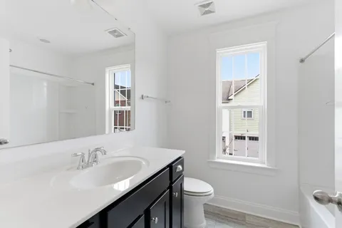 a bathroom with a sink toilet a mirror and shower