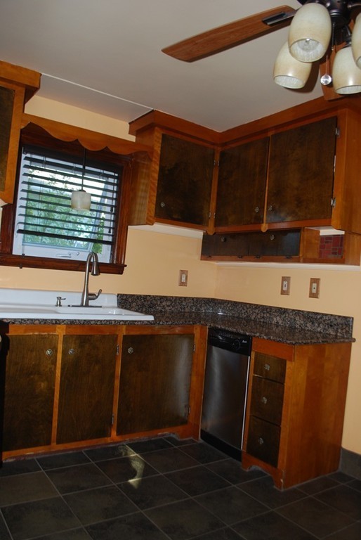 93 Detroit Street Fall River, MA 02721 - Photo 8 of 14 a kitchen with stainless steel appliances granite countertop a sink and a microwave