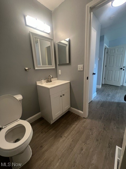 10422 Reno Avenue Cleveland, OH 44105 - Photo 9 of 21 Bathroom with vanity, toilet, and hardwood / wood-style floors