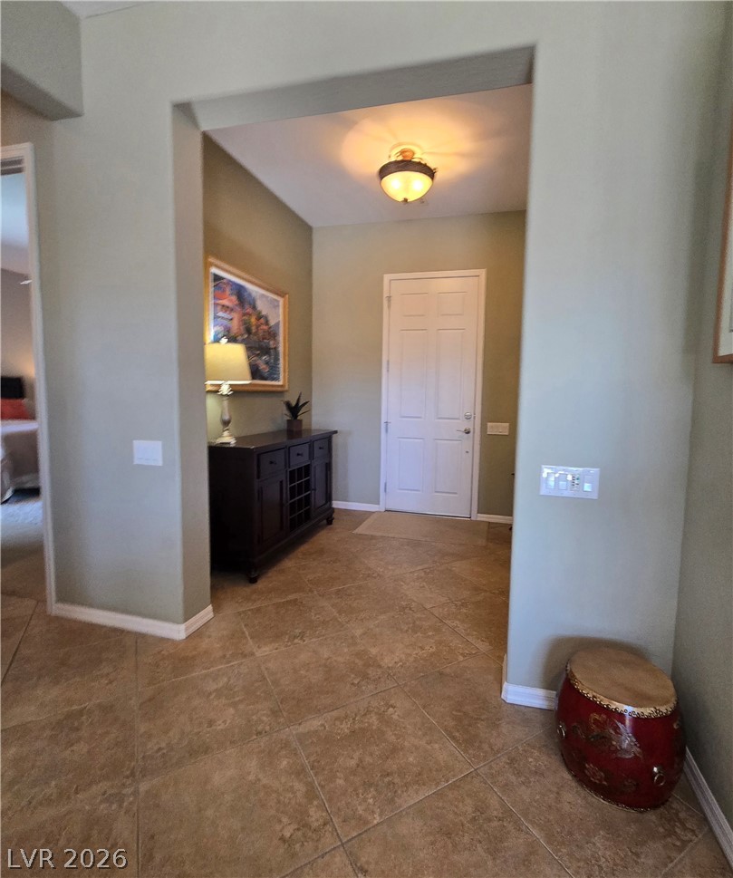 2567 Dirleton Place Henderson, NV 89044 - Photo 26 of 67 A welcoming entryway with durable tile flooring and a light fixture illuminating the space.