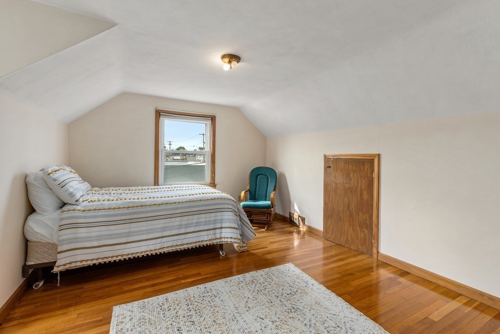3 East Street Springfield, MA 01104 - Photo 19 of 29 a bedroom with a bed and wooden floor