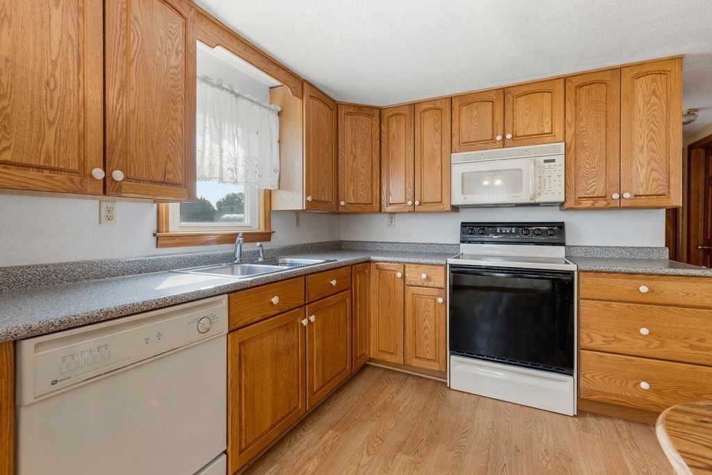3 East Street Springfield, MA 01104 - Photo 4 of 29 a kitchen with stainless steel appliances granite countertop a stove a sink and a microwave