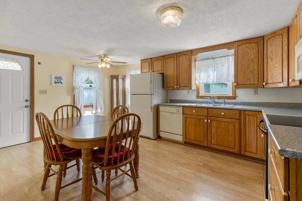 3 East Street Springfield, MA 01104 - Photo 6 of 29 a kitchen with granite countertop cabinets stainless steel appliances and a dining table