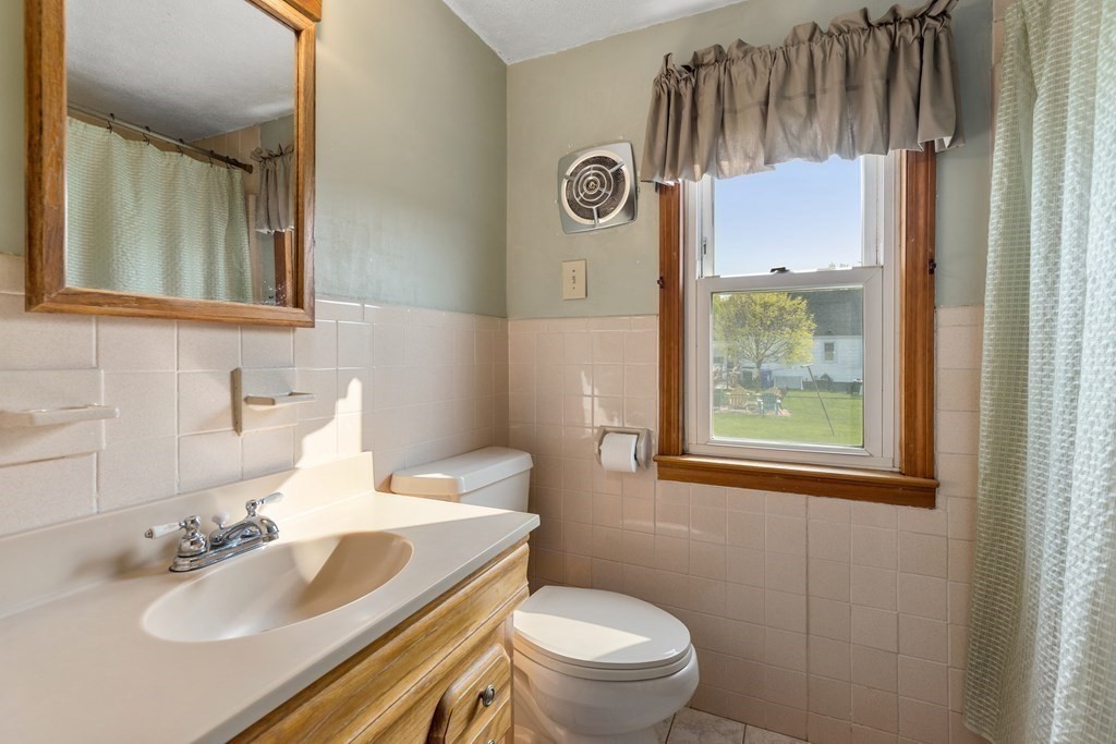 3 East Street Springfield, MA 01104 - Photo 10 of 29 a bathroom with a sink vanity mirror and toilet