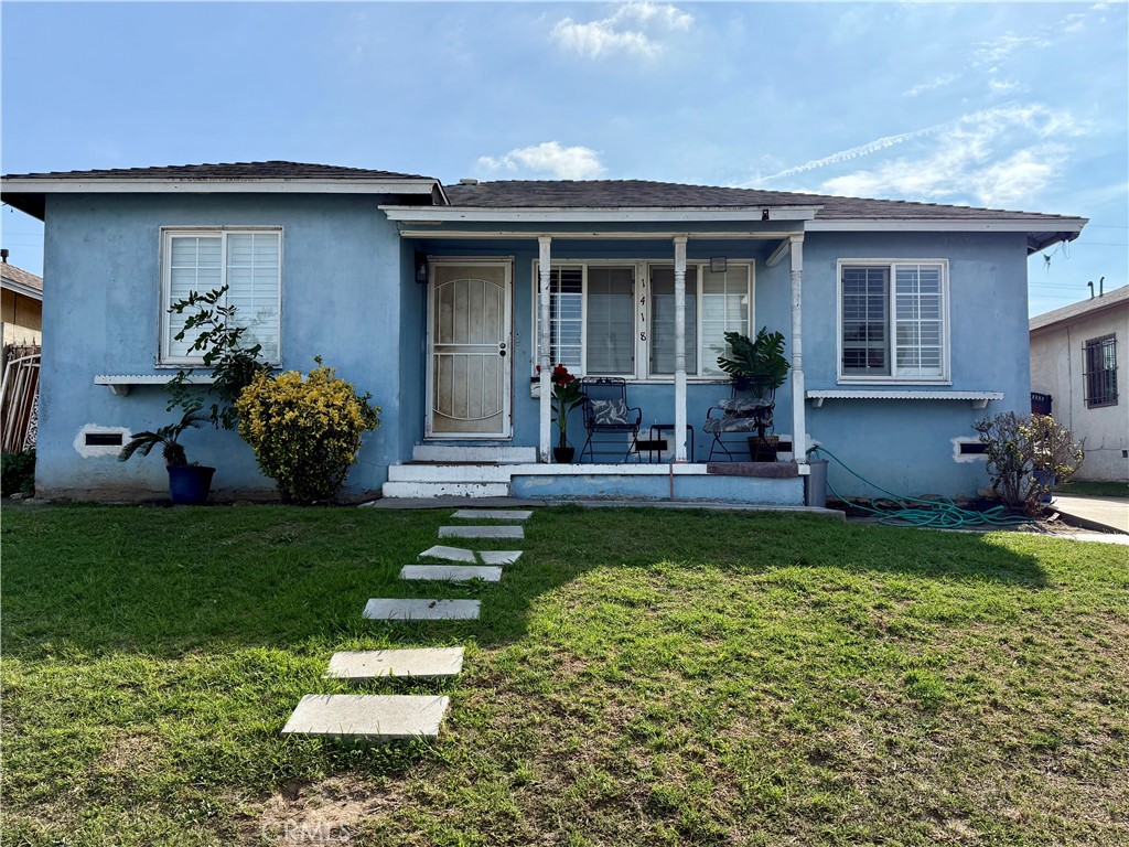 a front view of a house with a yard and porch