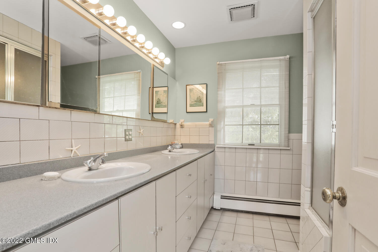 3 Wahneta Road Old Greenwich, CT 06870 - Photo 14 of 28 a bathroom with a sink a vanity and a mirror
