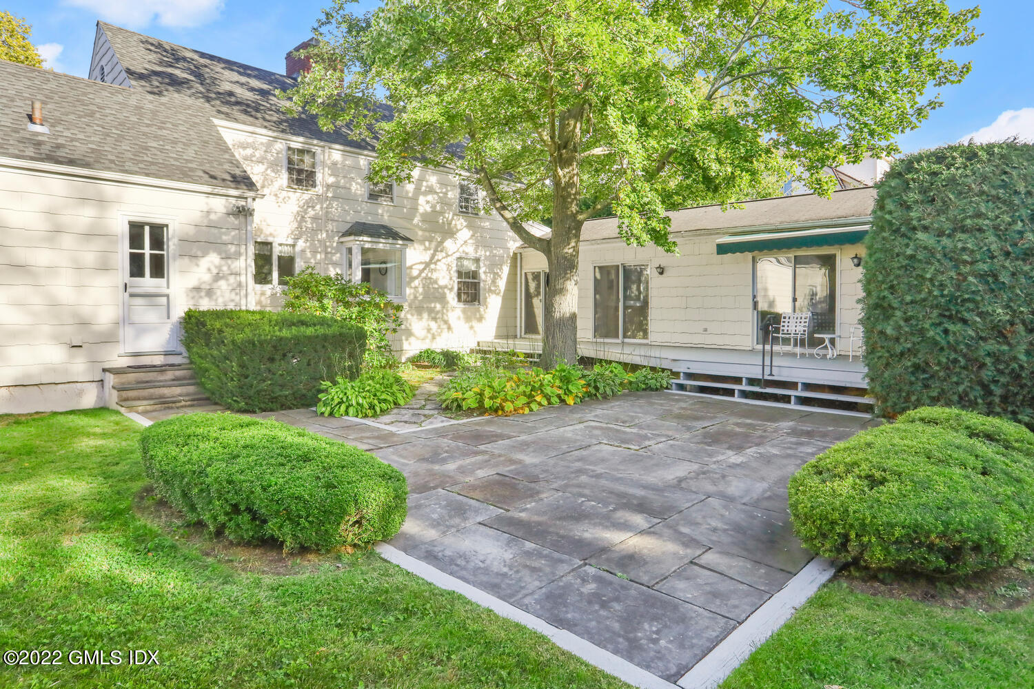 3 Wahneta Road Old Greenwich, CT 06870 - Photo 18 of 28 a front view of a house with a yard and potted plants