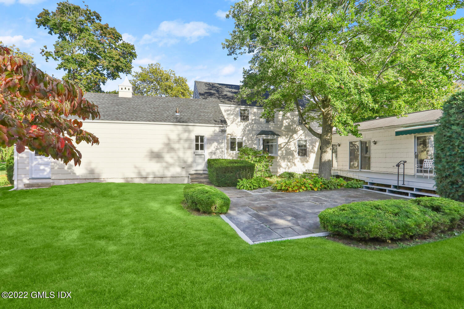 3 Wahneta Road Old Greenwich, CT 06870 - Photo 22 of 28 a view of backyard with table and chairs and a large tree
