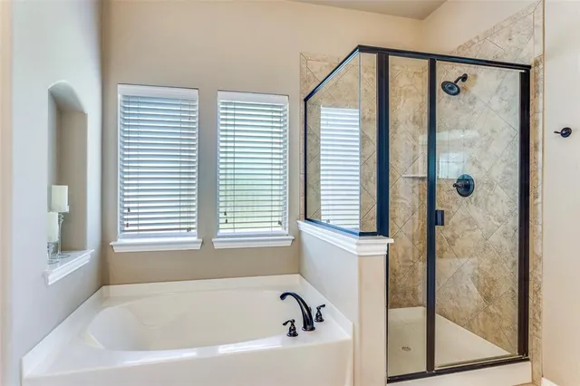 a bedroom with a bed and a ceiling fan