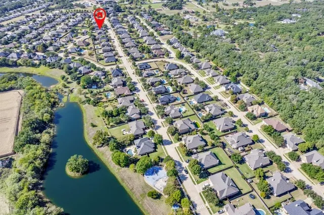 an aerial view of residential house with an outdoor space and seating
